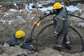 Workers from Ukraine's largest energy provider DTEK carry out emergency repairs of a power line in freezing conditions following Russian missile and drone attacks on Ukrainian energy infrastructure in Kyiv on 20 January 2026, amid the Russian invasion in Ukraine. (Photo by Genya SAVILOV / AFP via Getty Images)